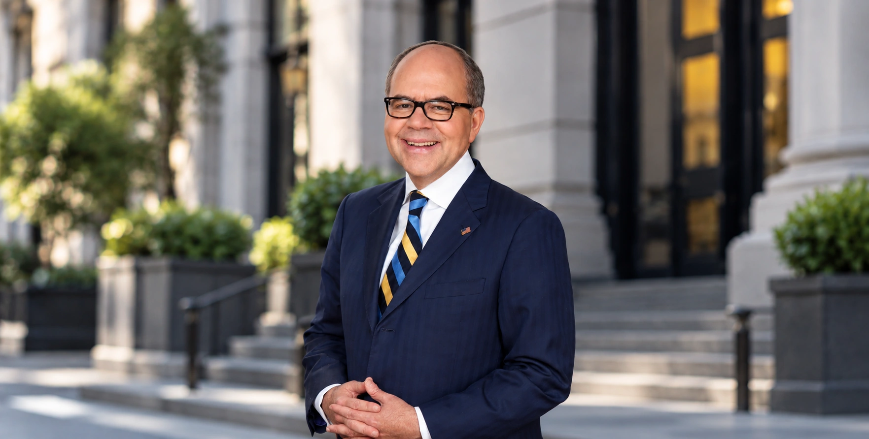Professional portrait of attorney Peter James Johnson in a navy suit and striped tie